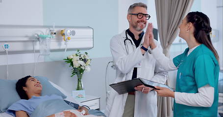 Image showing Happy man, doctor and high five with patient in success for healthcare or discharge on hospital bed. Male person, nurse or medical team touching hands in teamwork for diagnosis or results at clinic