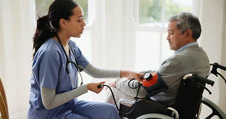 Image showing Blood pressure, nurse and old man in wheelchair in house for medical care, wellness or service. Healthcare, retirement home and caregiver with heart rate machine on person with disability for support