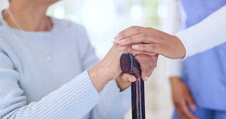 Image showing Nurse, holding hands and support woman with cane, empathy and trust in retirement home. Comfort, closeup of caregiver and senior person with a disability, walking stick and help, kindness and health