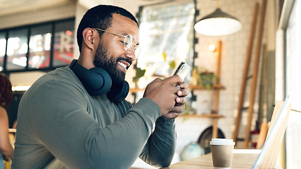 Image showing Remote work, cafe and man with a phone for a chat, communication or online search. Smile, entrepreneur or freelance worker typing on a mobile app at a coffee shop for contact, internet or connection