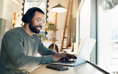 Image showing Man, remote work and laptop in cafe, headphones and productivity with freelancer and copywriter, writing article and blog. Workflow, typing on pc in coffee shop and copywriting with music or research