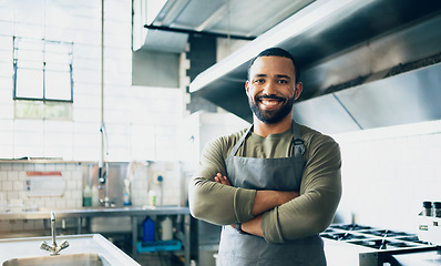 Image showing Happy man, chef and small business owner at restaurant for hospitality service, cooking or food in kitchen. Portrait of male person, employee or waiter smile in confidence for professional culinary