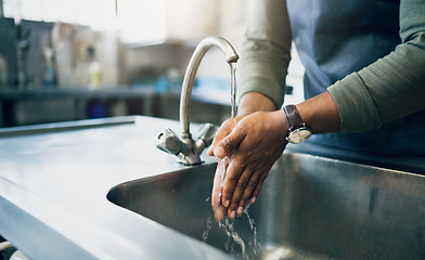 Image showing Water, safety and washing hands in the kitchen with a person by the sink for skincare or wellness. Cleaning, hygiene and bacteria with an adult closeup in the home to rinse for skin protection