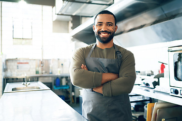 Image showing Happy man, chef and small business owner in kitchen at restaurant for hospitality service, cooking or food. Portrait of male person, employee or waiter smile in confidence for professional culinary