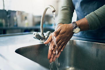 Image showing Water, hygiene and washing hands in the kitchen with a person by the sink for health or wellness. Cleaning, safety and bacteria with an adult closeup in the home to rinse for skin protection