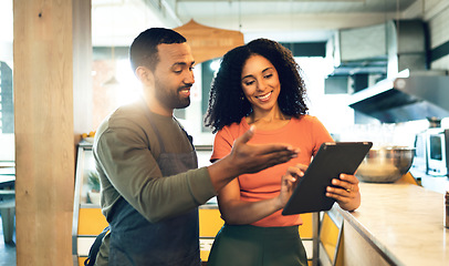 Image showing Coffee shop, talking and man with a woman and tablet for online orders, retail information and advice. Happy, ecommerce and a business owner with a waiter and technology reading review on the web