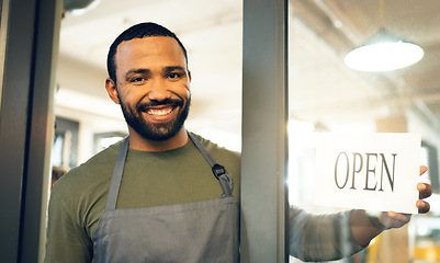 Image showing Happy man, portrait and small business with open sign on door in ready for service or welcome at cafe. Male person, barista or waiter smile by entrance of coffee shop, restaurant or cafeteria store