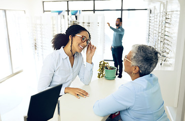 Image showing Optometry, consulting or happy woman with glasses for vision in a retail optical or eyewear store. Shopping, talking or biracial customer with new spectacles or senior optometrist at optics clinic