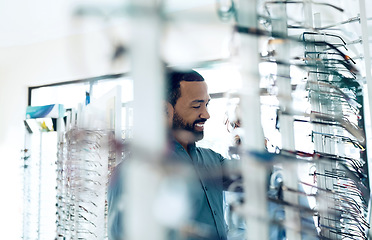 Image showing Optometry, glasses and man for eye care decision, choice and options in optician store for vision. Healthcare, ophthalmology and person in clinic to choose prescription lens, spectacles and frames