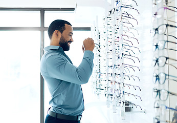 Image showing Ophthalmology, glasses and man for eye care decision, choice and options in optician store for vision. Healthcare, optometry and person in clinic to choose prescription lens, spectacles and frames