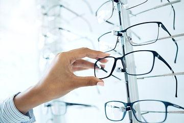 Image showing Optometry store, glasses and hands of person for lens frame decision, retail shop choice or eyewear sales. Eye care clinic, vision eyesight support and closeup client, customer and choose eyeglasses