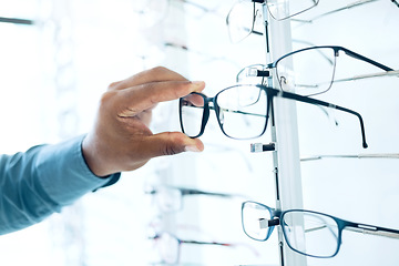 Image showing Optometry shop, eyeglasses and hands of person shopping for retail sales decision, optical clinic product or prescription eyewear. Shelf option, ocular accessory and closeup client choice for glasses