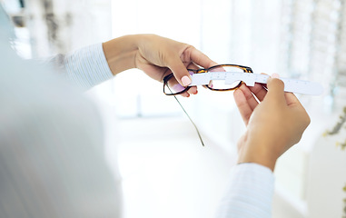 Image showing Eye care, hands measure lens and frame of glasses, person in optometry clinic with test and healthcare. Eyewear, wellness and prescription with health, spectacles and optometrist with ruler tools