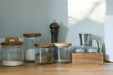 Image showing various containers on kitchen table