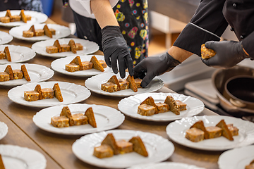 Image showing Chefs are arranging meat and toast bread pieces