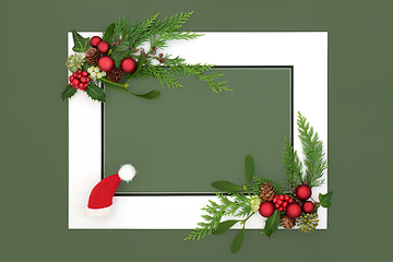 Image showing Christmas Eve Background Border with Santa Hat Baubles and Flora