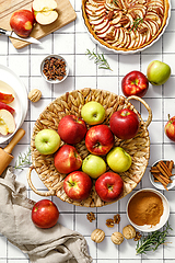 Image showing Apple. Fresh raw juicy red and green apples in a basket on a kitchen table with ingredients for cooking Thanksgiving autumn season apple pie, top view