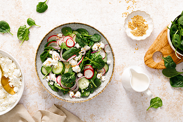 Image showing Spinach and cottage cheese fresh green vegetable salad with radish, cucumber and yogurt, healthy diet food, top view