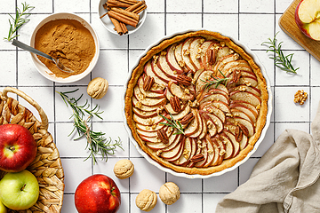 Image showing Apple pie. Apple tart with cinnamon, walnuts and pecan nuts, top view