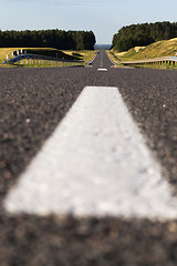 Image showing close-up of an asphalt road with white road markings