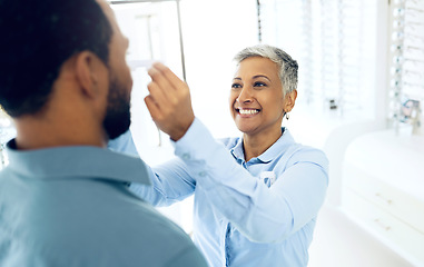 Image showing Woman optometrist, fitting and customer in store with consultation for helping health and vision. Happy client, optician and eye care equipment with appointment, prescription glasses and reading