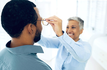 Image showing Optometrist, eye care service or man with glasses for vision in a retail optical or eyewear shop. Happy woman, choice or customer with new spectacles, frame or mature doctor at optics clinic store