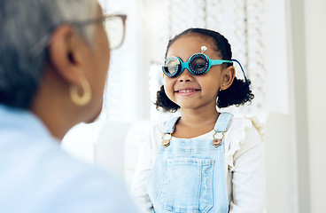 Image showing Vision, glasses or eye test with a girl and optician in an eyewear store for prescription frame lenses. Medical, consulting or spectacles with a young child and woman optometrist in an office