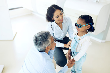 Image showing Optometry, glasses and optometrist with child and mother at an eye care appointment for test. Health, wellness and senior optician with young mom and girl kid patient with lenses in an optical clinic