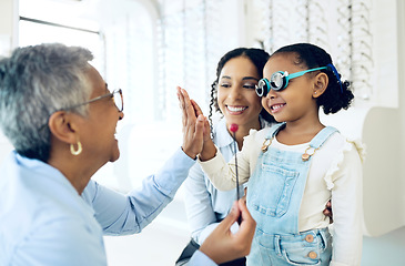 Image showing High five, children and a family with a happy optometrist in a clinic for an eye exam to test for prescription frame lenses. Support, motivation or trust with a girl and her parent at the optician