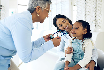 Image showing Optical, glasses and optometrist with child and mother at an eye care appointment for test. Health, wellness and senior optician with young mom and girl kid patient with lenses in an optometry clinic