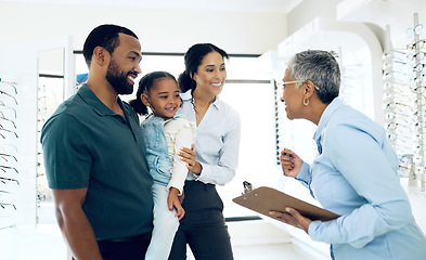 Image showing Family, optometry and eye care with a woman optometrist in a clinic to see a patient for vision assessment. Mother, father and daughter at the optician for an appointment to test eyesight for kids