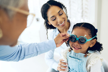 Image showing Trial lens, optometry and optometrist with child and mother at eye care appointment for vision test. Health, medical and senior optician with mom and girl kid patient with tool in an optical clinic.