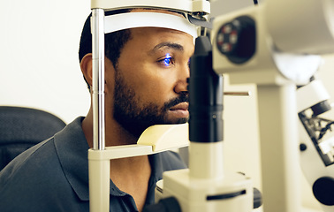Image showing Man, eye exam and ophthalmology for medical, vision and healthcare consultation with glaucoma check. African person or client with laser, blue light and machine for scanning and optometry in office