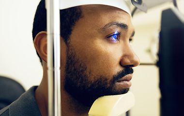 Image showing Man, face and eye exam with vision and laser machine, health and vision with closeup, optometry and wellness at clinic. Patient, healthcare and scan retina for assessment, prescription and technology