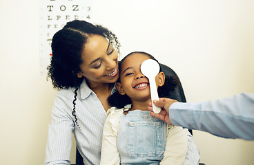 Image showing Optometry, vision test and optometrist with child and mother at an eye care appointment for consultation. Health, medical and optician with young mom and girl kid patient with tool in optical clinic.