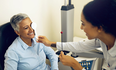 Image showing Woman, eye exam and occluder with optometrist in clinic, check and lens for vision, wellness or healthcare. Doctor, eyesight tools and smile for help in assessment, consultation or cover in hospital