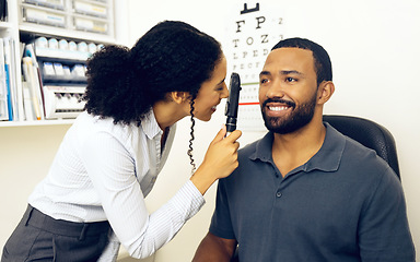 Image showing Patient, eye care and healthcare in clinic with ophthalmoscope to check for glaucoma, ocular services and assessment. Optician, woman and retina analysis for eyesight of happy man with expert tools