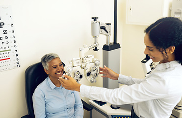 Image showing Woman, eye exam and phoropter for ophthalmologist with check, lens or vision for wellness in clinic. Doctor, eyesight tools or machine for healthcare with smile, consultation or glasses in hospital