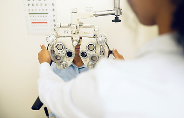 Image showing Woman, eye exam and phoropter for optometrist with health check, lens or vision for wellness in clinic. Doctor, eyesight tools or machine for help with assessment, consultation or glasses in hospital