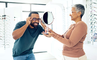 Image showing Mirror, glasses and optometrist help happy man in store for choice of lens, frame and consultation. Smile, reflection and mature optician with patient for spectacles, healthy vision and ophthalmology