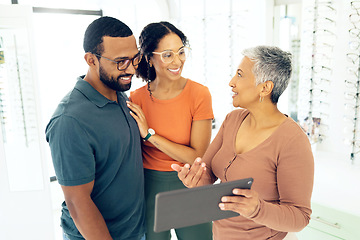 Image showing Optometry, couple and employee with tablet, help and conversation with retail, service and company website. Man, woman and customers with consultant, sales person and technology for stock or shopping