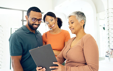 Image showing Eye test results, talking and woman with a couple, glasses and a tablet for online information. Optometry, happy and a man and woman with an optometrist and technology for vision and eyewear shopping