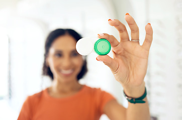 Image showing Hand, vision and contact lens container with a person at the optometrist for eye care or health closeup. Healthcare, medical and plastic case with a customer at the optician for a checkup appointment