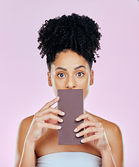 Image showing Portrait, eating and woman with chocolate, sugar and diabetes on a pink studio background. Face, person and model with unhealthy food, cacao treat and sweet diet with expression, nutrition and snack