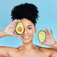 Image showing Happy woman, portrait and avocado for skincare, diet or natural beauty against a blue studio background. Face of female person smile with organic fruit for nutrition, vitamin C or skin wellness