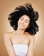 Image showing Hair, shake curls and wind, woman with beauty and treatment for shine, cosmetic care and smile on studio background. Wellness, haircare and growth with strong texture and curly locks, volume and afro