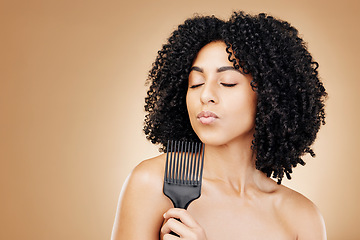 Image showing Hair care, comb and curly woman in a studio with young, natural and salon treatment. Health, beauty and female model from Mexico with cosmetic tool for healthy hairstyle isolated by brown background.