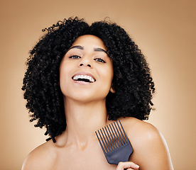 Image showing Portrait, hair care and woman with a comb, afro and salon treatment with volume on brown background. Face, person or model with grooming, shine or glow with beauty, texture or aesthetic with keratin