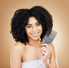 Image showing Portrait, hair care and woman with a comb, curls and salon grooming with keratin on brown background. Face, person or model with beauty, shine or glow with volume, cosmetics or smile with aesthetic