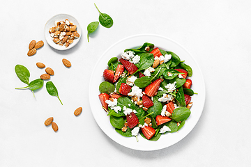 Image showing Strawberry and spinach fresh salad with cottage cheese and almonds, top view